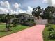 House with pink driveway and landscaped front yard at 3115 Albert St, Orlando, FL 32806