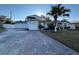 Inviting home featuring a large driveway, three-car garage and well-manicured lawn with a prominent palm tree at 3115 Albert St, Orlando, FL 32806