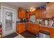 Kitchen with wood cabinets and door to backyard at 3115 Albert St, Orlando, FL 32806