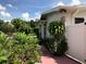 Sidewalk with lush landscaping and white fence at 3115 Albert St, Orlando, FL 32806