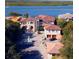 Breathtaking aerial view of an estate with lush landscaping, a circular driveway and waterfront at 4852 S Peninsula Dr, Ponce Inlet, FL 32127