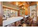Custom bar area with marble countertop, mosaic details, carved wooden bar stools, and a glass display for liquor at 4852 S Peninsula Dr, Ponce Inlet, FL 32127