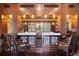 Built-in bar area with granite countertops, custom cabinetry, and mosaic accents at 4852 S Peninsula Dr, Ponce Inlet, FL 32127