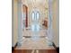 Elegant bathroom with marble columns, arched windows, soaking tub, and chandelier at 4852 S Peninsula Dr, Ponce Inlet, FL 32127