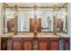 Elegant bathroom features dual vanities with marble countertops and decorative mirrors at 4852 S Peninsula Dr, Ponce Inlet, FL 32127