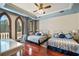 Bright bedroom with hardwood floors and balcony access with desk at 4852 S Peninsula Dr, Ponce Inlet, FL 32127