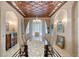 Formal dining room featuring a long dining table, elegant lighting, and custom ceiling at 4852 S Peninsula Dr, Ponce Inlet, FL 32127