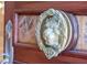 Ornate lion's head door knocker with surrounding floral wreath detail at 4852 S Peninsula Dr, Ponce Inlet, FL 32127