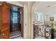 Enjoy the convenience of an elevator in this home with a decorative iron gate and hardwood door at 4852 S Peninsula Dr, Ponce Inlet, FL 32127