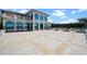 Expansive stone patio leading to a beautiful home with arched windows at 4852 S Peninsula Dr, Ponce Inlet, FL 32127
