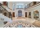 Elegant foyer featuring marble floors, staircase, and a decorative archway, exuding luxury and sophistication at 4852 S Peninsula Dr, Ponce Inlet, FL 32127