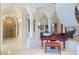 Grand foyer featuring high ceilings, marble floors, a piano, and custom accents at 4852 S Peninsula Dr, Ponce Inlet, FL 32127