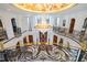 Grand foyer featuring a winding staircase, chandelier, marble floors, and custom iron railings at 4852 S Peninsula Dr, Ponce Inlet, FL 32127