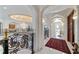 Grand foyer with wrought iron railings, marble floors, a ceiling mural, and a crystal chandelier at 4852 S Peninsula Dr, Ponce Inlet, FL 32127