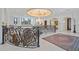 Grand foyer with wrought iron railings, marble floors, a ceiling mural, and a crystal chandelier at 4852 S Peninsula Dr, Ponce Inlet, FL 32127