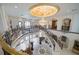 Grand foyer featuring a winding staircase, chandelier, marble floors, and custom iron railings at 4852 S Peninsula Dr, Ponce Inlet, FL 32127