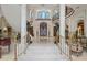 Elegant foyer featuring marble floors, a grand staircase, and statues at 4852 S Peninsula Dr, Ponce Inlet, FL 32127