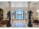Stunning foyer with marble floors, soaring columns, and statues framing picturesque views of a pool at 4852 S Peninsula Dr, Ponce Inlet, FL 32127