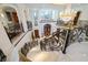 Grand foyer showcasing a spiral staircase, marble floors, and a large decorative chandelier at 4852 S Peninsula Dr, Ponce Inlet, FL 32127