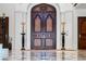 Impressive double front door with detailed design and marble pillars at 4852 S Peninsula Dr, Ponce Inlet, FL 32127