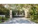 View of the front gate to the property featuring stone columns and a black metal gate at 4852 S Peninsula Dr, Ponce Inlet, FL 32127