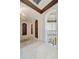 Hallway with marble floors, archways and decorative lighting with unique wooden doors at 4852 S Peninsula Dr, Ponce Inlet, FL 32127