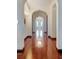Hallway with hardwood floors, arched doorway and chandelier at the end at 4852 S Peninsula Dr, Ponce Inlet, FL 32127