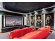 Enjoy this home theater with red leather recliners, movie posters, and starry sky ceiling at 4852 S Peninsula Dr, Ponce Inlet, FL 32127