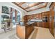 Gourmet kitchen features stainless appliances, wood cabinetry, and a large island with granite countertops at 4852 S Peninsula Dr, Ponce Inlet, FL 32127