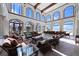 Bright, open living room with tile floors, beamed ceilings, arched windows and water views at 4852 S Peninsula Dr, Ponce Inlet, FL 32127