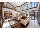 Spacious living room features high ceilings, large windows, and views of the pool at 4852 S Peninsula Dr, Ponce Inlet, FL 32127
