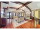 Primary bedroom with decorative ceiling beams, seating area, and hardwood flooring at 4852 S Peninsula Dr, Ponce Inlet, FL 32127