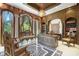 Luxurious home office featuring custom woodwork, ornate details, and abundant natural light from large windows at 4852 S Peninsula Dr, Ponce Inlet, FL 32127