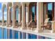 Gorgeous pool features lounge chairs and classical columns at 4852 S Peninsula Dr, Ponce Inlet, FL 32127
