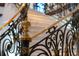 Detailed view of the staircase with wrought iron and gold accents at 4852 S Peninsula Dr, Ponce Inlet, FL 32127