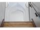 Elegant stairway with marble steps and arched ceilings, accented by sconces at 4852 S Peninsula Dr, Ponce Inlet, FL 32127