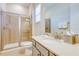 Bathroom with glass enclosed shower, granite vanity, and neutral paint at 3001 Sea Plane Ln, Kissimmee, FL 34747