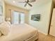 Bedroom with tile flooring, ceiling fan, and door to the outside at 3001 Sea Plane Ln, Kissimmee, FL 34747