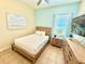 Cozy bedroom featuring tile floors, small dresser, and a mounted tv at 3001 Sea Plane Ln, Kissimmee, FL 34747