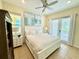 Bright bedroom featuring tile floors, ceiling fan, and sliding glass doors to the patio at 3001 Sea Plane Ln, Kissimmee, FL 34747