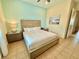 This bedroom features a king bed, two nightstands, and tile flooring at 3001 Sea Plane Ln, Kissimmee, FL 34747