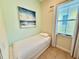 Small bedroom with tile flooring and natural light from a window at 3001 Sea Plane Ln, Kissimmee, FL 34747