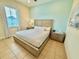 Bright bedroom featuring tile floors, two dressers, and natural light at 3001 Sea Plane Ln, Kissimmee, FL 34747