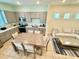Open concept living room showcasing a view to the modern kitchen and dining area with stainless appliances at 3001 Sea Plane Ln, Kissimmee, FL 34747
