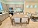 Eat-in kitchen showcasing stainless appliances, plenty of cabinets and a wooden dining table at 3001 Sea Plane Ln, Kissimmee, FL 34747