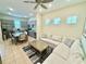 Open concept living room showcasing a view to the modern kitchen and dining area with stainless appliances at 3001 Sea Plane Ln, Kissimmee, FL 34747