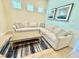 Bright living room featuring a comfortable sectional sofa, stylish rug, and neutral decor at 3001 Sea Plane Ln, Kissimmee, FL 34747