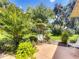Charming backyard patio surrounded by lush landscaping and mature trees, creating a serene outdoor space at 966 N Ronald Reagan Blvd, Longwood, FL 32750