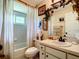 Well-maintained bathroom with shower-tub combo, vanity and decorative accents at 966 N Ronald Reagan Blvd, Longwood, FL 32750