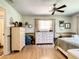 Light-filled bedroom with laminate flooring, neutral walls, and modern furnishings at 966 N Ronald Reagan Blvd, Longwood, FL 32750